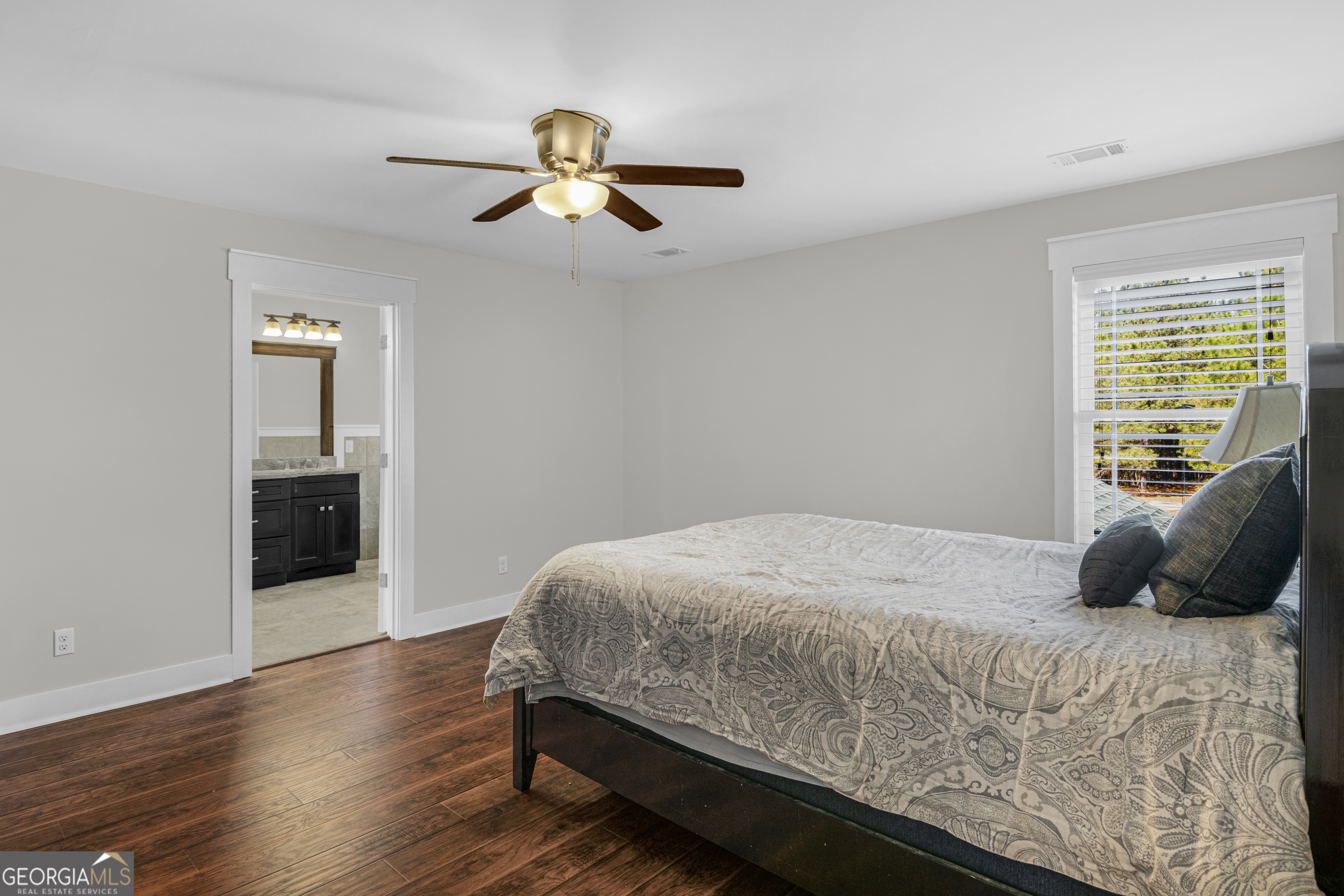 328 Windsor Road Guyton, GA 31312 - Photo 30 of 39 a bedroom with a bed and wooden floor