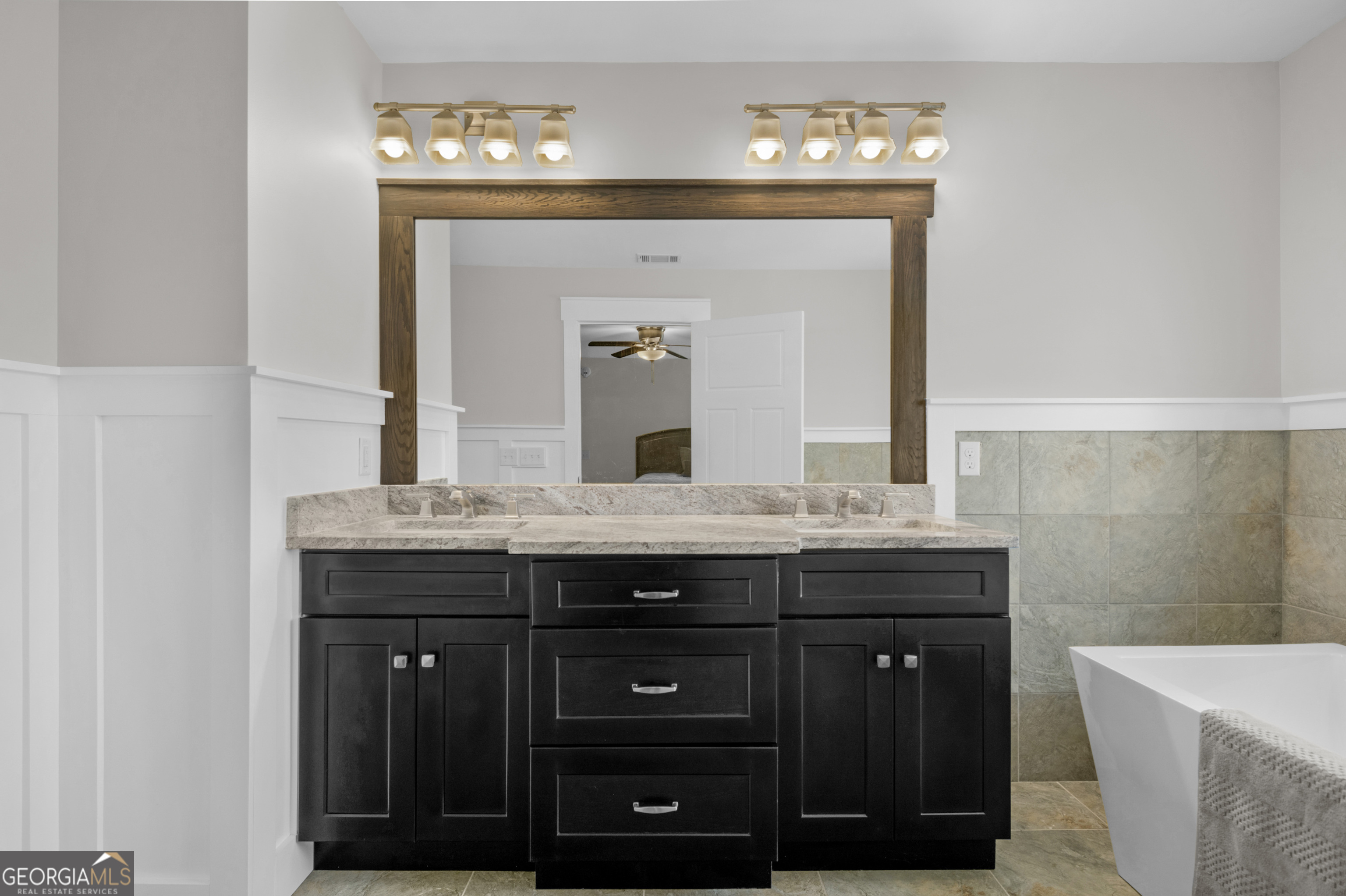 328 Windsor Road Guyton, GA 31312 - Photo 31 of 39 a bathroom with a granite countertop sink and a mirror