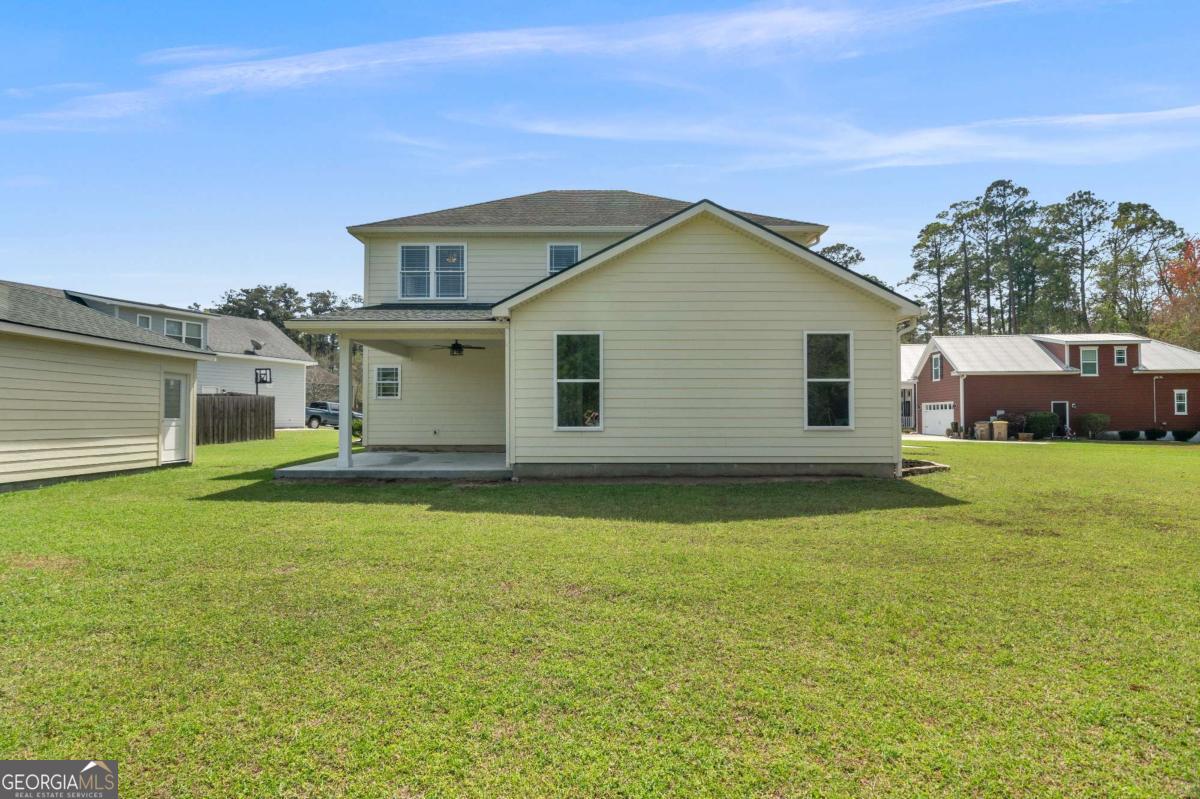 328 Windsor Road Guyton, GA 31312 - Photo 33 of 39 a view of a house with a backyard