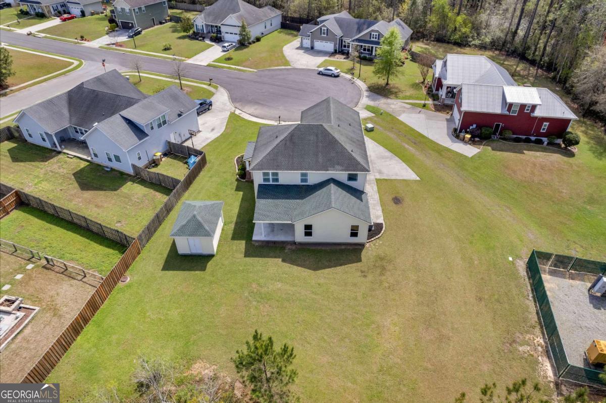 328 Windsor Road Guyton, GA 31312 - Photo 36 of 39 an aerial view of a house with swimming pool and large trees