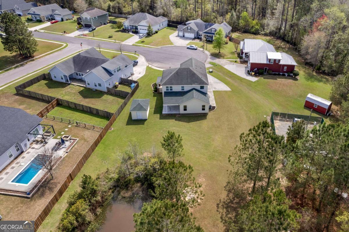 328 Windsor Road Guyton, GA 31312 - Photo 37 of 39 an aerial view of a house with yard swimming pool and outdoor seating
