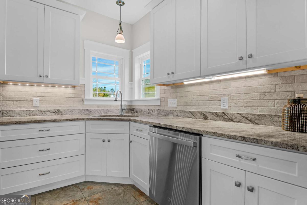 328 Windsor Road Guyton, GA 31312 - Photo 7 of 39 a kitchen with granite countertop white cabinets and a sink