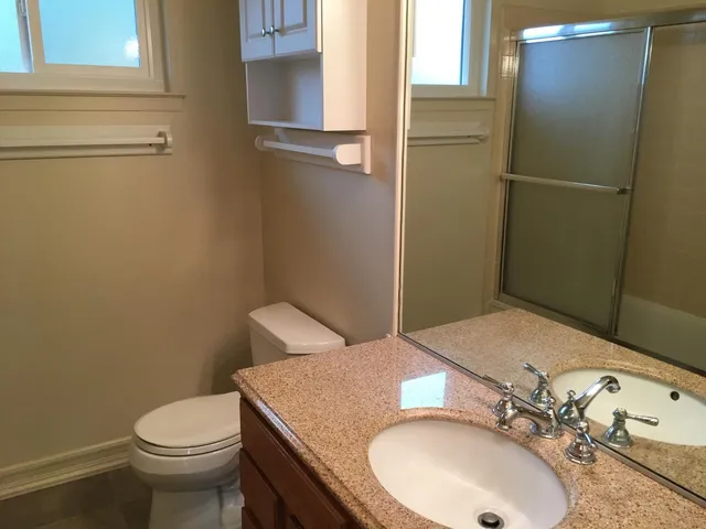 a bathroom with a sink toilet and mirror