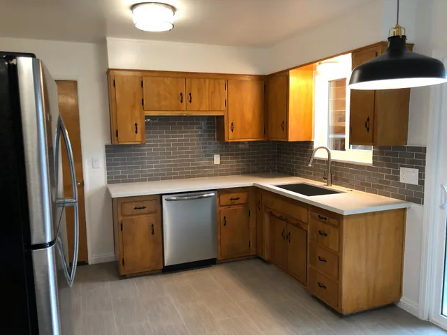 a kitchen with a sink stove and refrigerator