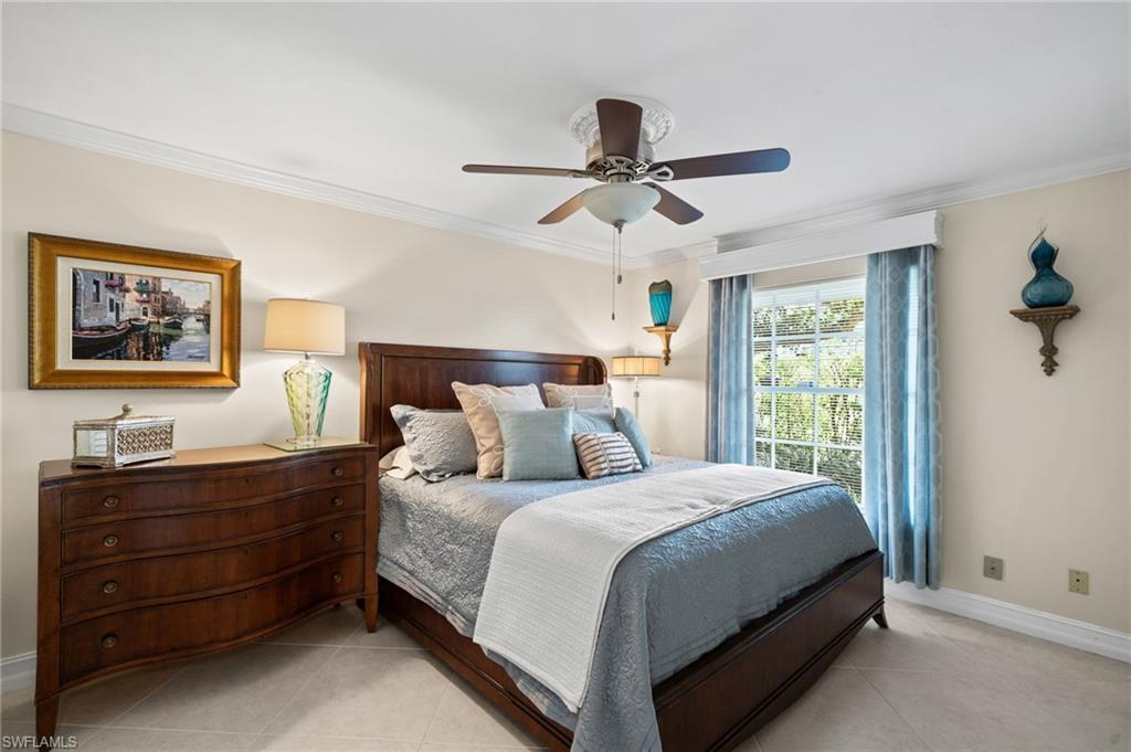 547 Devils Lane Naples, FL 34103 - Photo 11 of 13 a bedroom with a bed dresser and a window