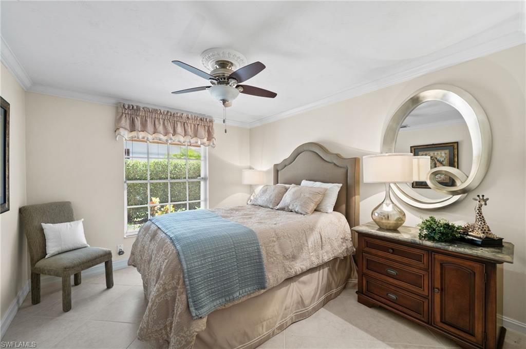 547 Devils Lane Naples, FL 34103 - Photo 13 of 13 a bedroom with a bed and window