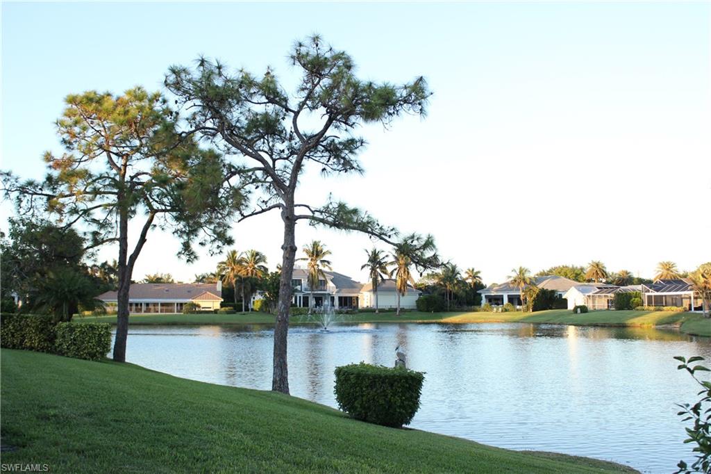 547 Devils Lane Naples, FL 34103 - Photo 2 of 13 a view of a lake with houses in the back