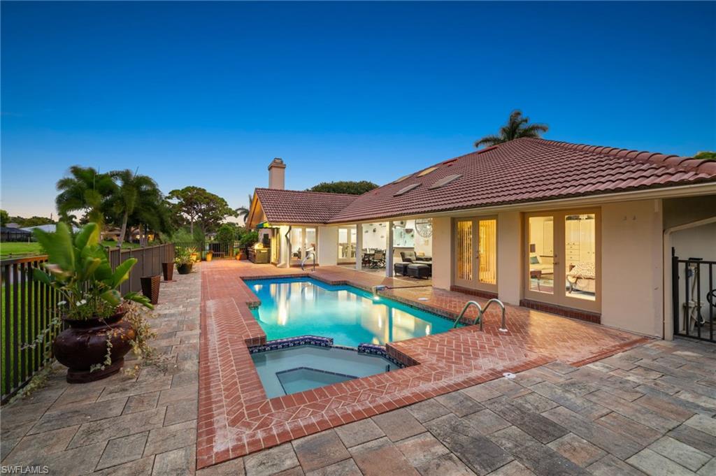 547 Devils Lane Naples, FL 34103 - Photo 3 of 13 a front view of a house with garden