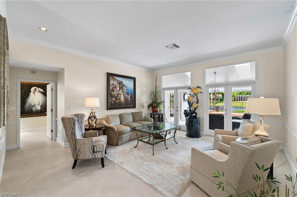 547 Devils Lane Naples, FL 34103 - Photo 8 of 13 a living room with furniture and a large window