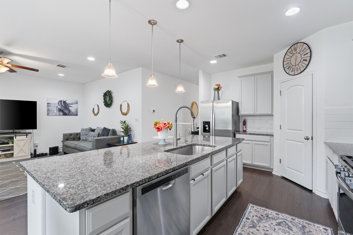 a kitchen with a sink counter top space and a center island