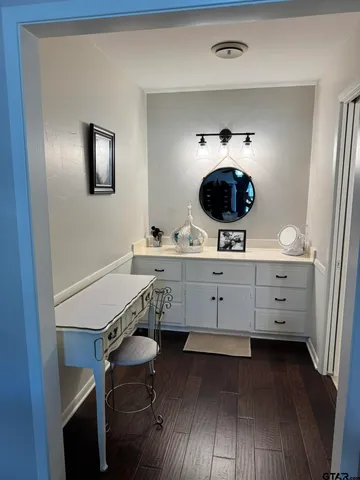 a room with a table chairs and wooden floor