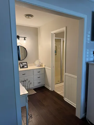 a room with a mirror and a wooden floor