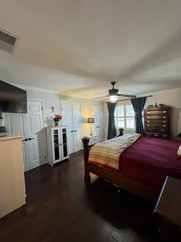 a bedroom with furniture and wooden floor
