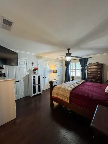 a bedroom with a bed and dresser