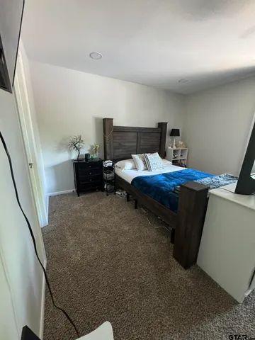 a bedroom with bed and window