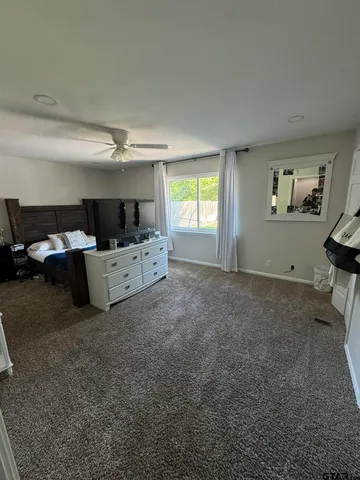 a bed room with furniture and window