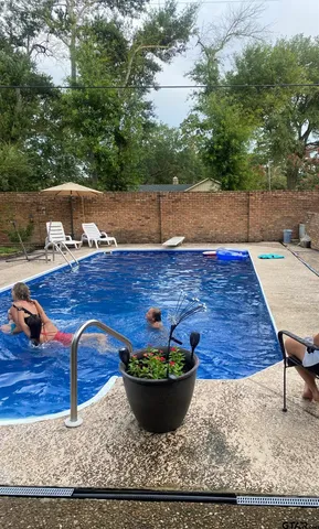 a view of a backyard with wooden tub