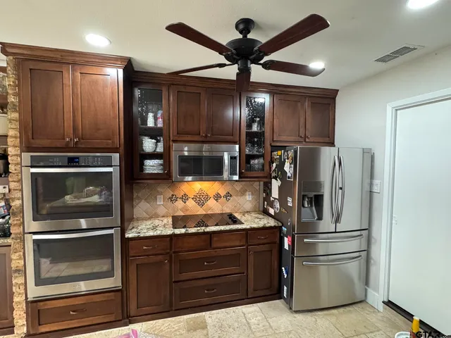 a kitchen with refrigerator and cabinets