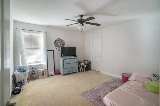 a bedroom with a bed and a tv