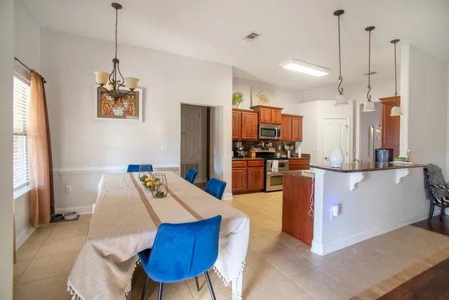 a living room with stainless steel appliances kitchen island granite countertop furniture and a view of kitchen