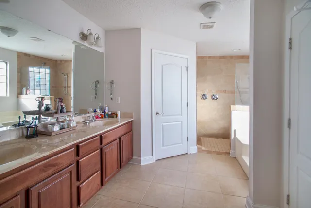 a bathroom with a sink and mirror with toilet