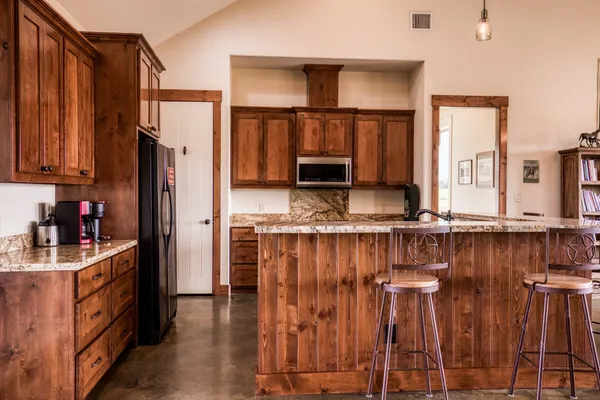 a kitchen with stainless steel appliances granite countertop a stove top oven a sink and dishwasher