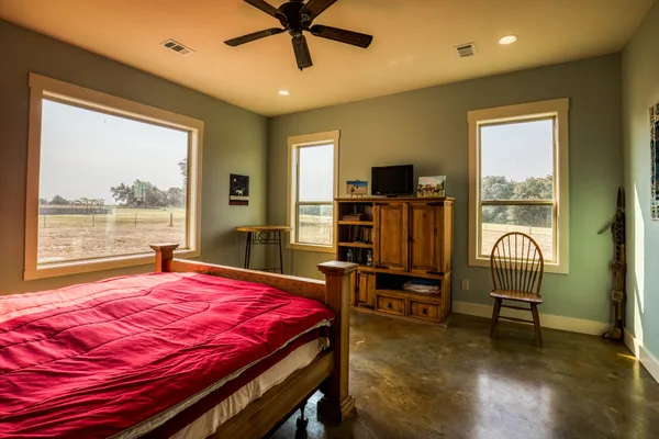 a bedroom with a bed and a desk
