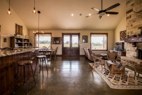 a living room with furniture a flat screen tv and a fireplace