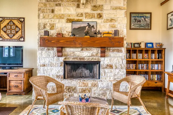 a view of a livingroom with furniture a fireplace and wooden floor