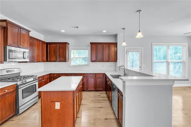 a kitchen with a sink stove and cabinets