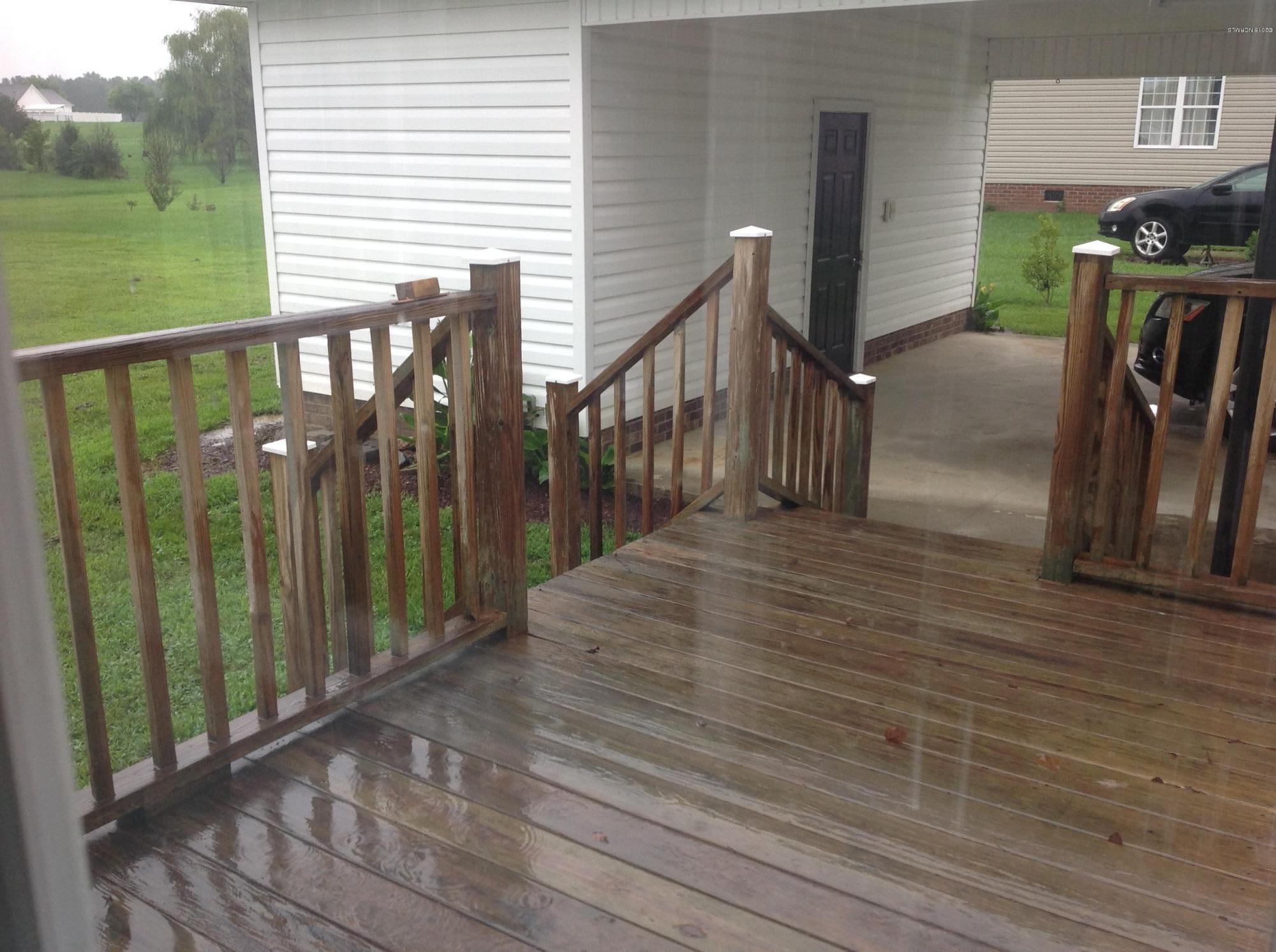 932 Green Road Spring Hope, NC 27882 - Photo 11 of 13 Nice deck with steps to back yard and also to carport. Deck is off kitchen/dining door