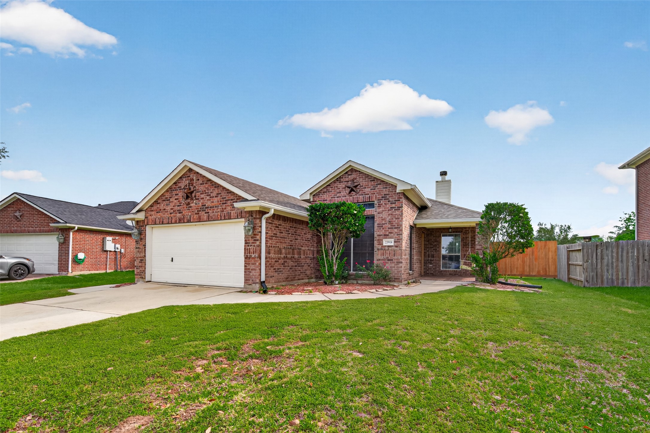 23914 Glengate Drive Spring, TX 77373 - Photo 3 of 49 a front view of a house with a yard and garage