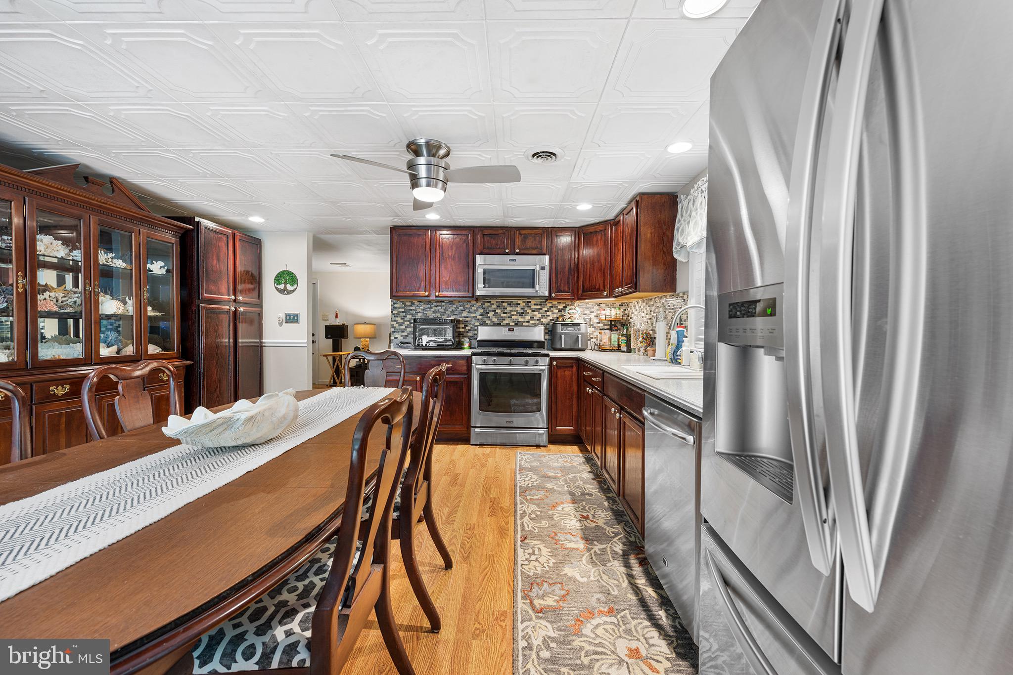 405 East Millstream Road Cream Ridge, NJ 08514 - Photo 12 of 37 a kitchen with stainless steel appliances granite countertop a refrigerator a stove top oven a sink and dishwasher