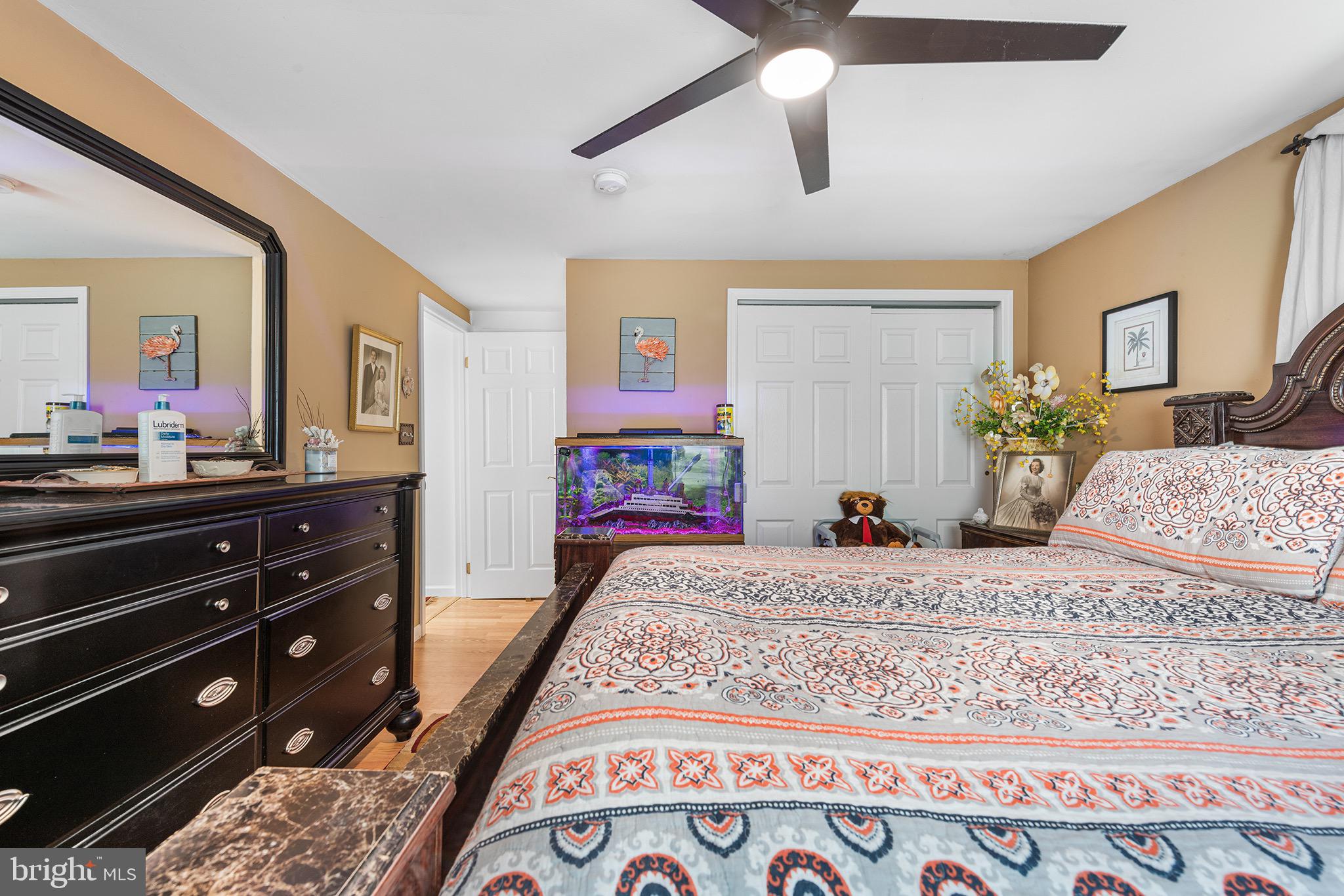 405 East Millstream Road Cream Ridge, NJ 08514 - Photo 16 of 37 a large bedroom with a bed and a dresser in it