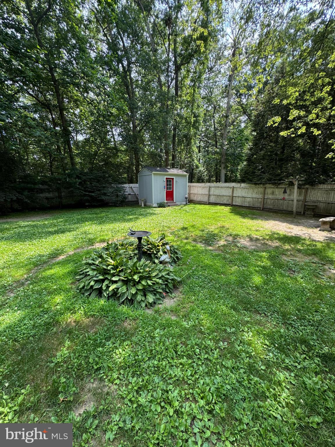 405 East Millstream Road Cream Ridge, NJ 08514 - Photo 31 of 37 a backyard of a house with lots of green space and fountain