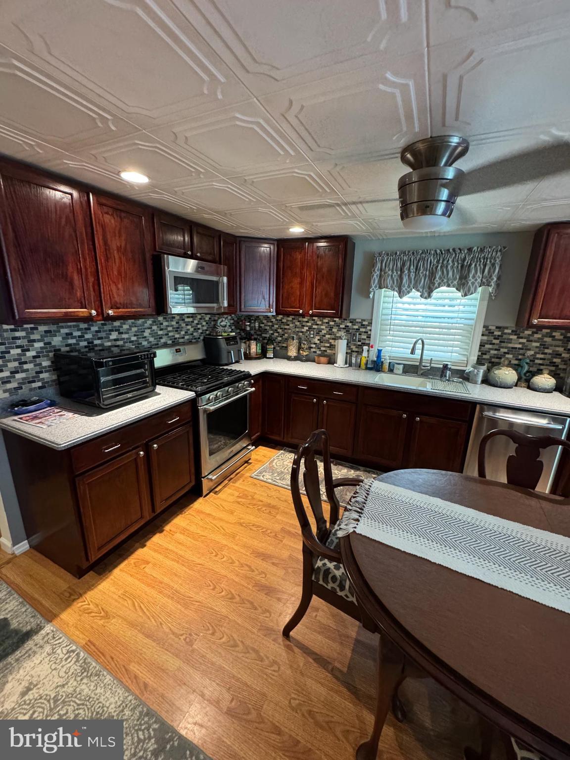 405 East Millstream Road Cream Ridge, NJ 08514 - Photo 7 of 37 a kitchen with a stove a sink and a refrigerator