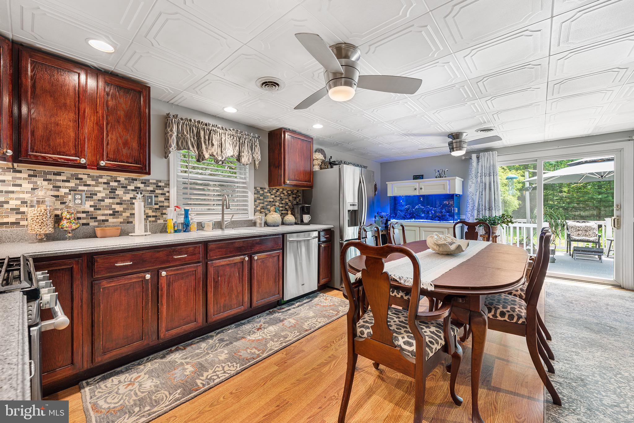 405 East Millstream Road Cream Ridge, NJ 08514 - Photo 9 of 37 a dining table with chairs and kitchen view