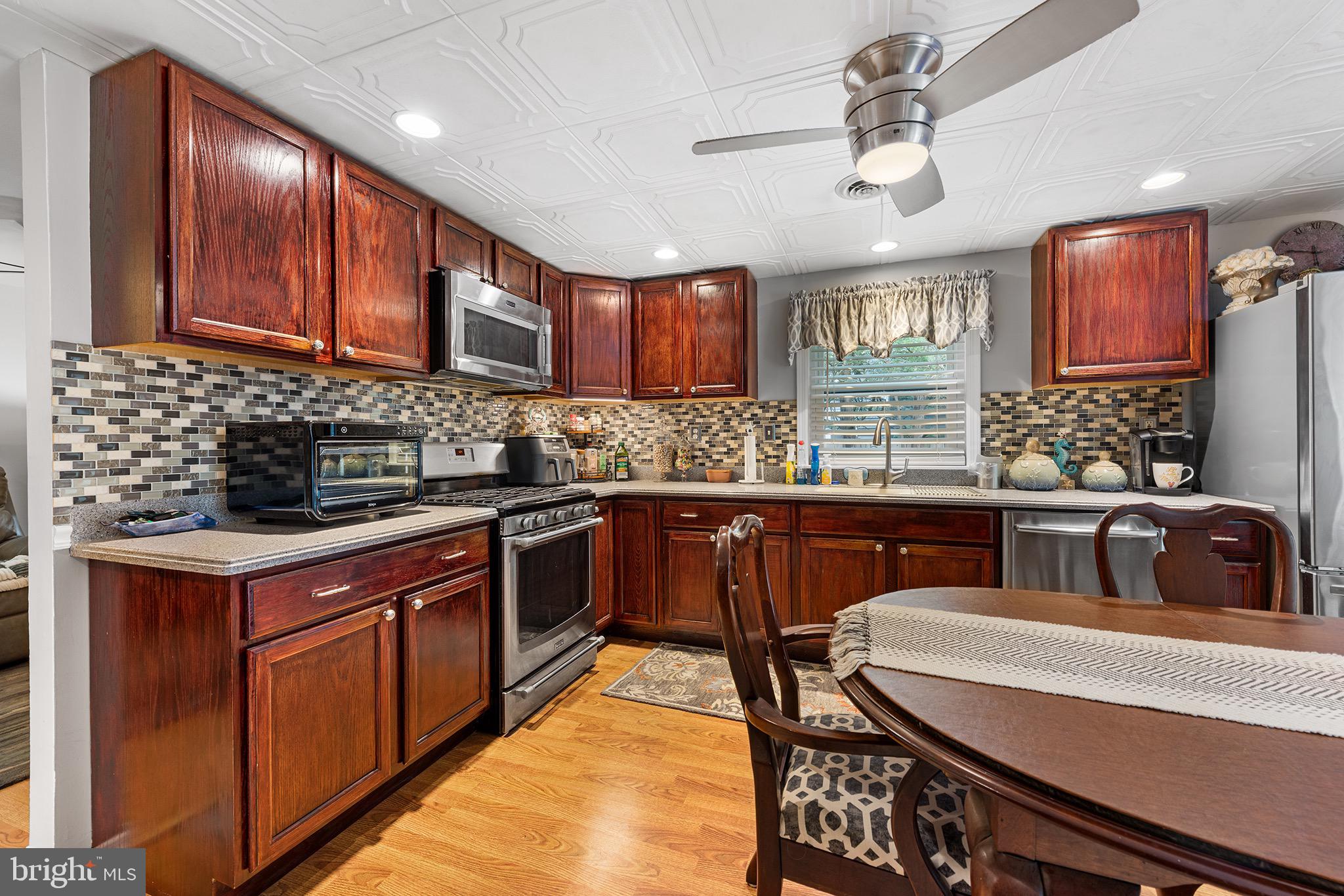 405 East Millstream Road Cream Ridge, NJ 08514 - Photo 10 of 37 a kitchen with stainless steel appliances granite countertop a sink stove and cabinets
