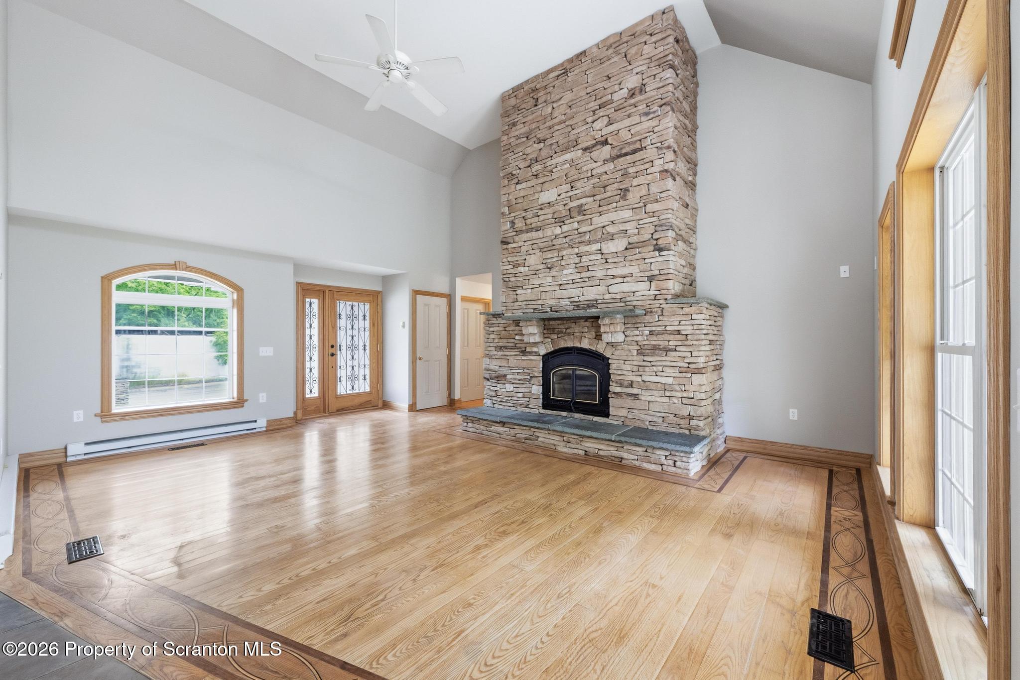 116 Forge Street Old Forge, PA 18518 - Photo 5 of 49 an empty room with windows and fireplace