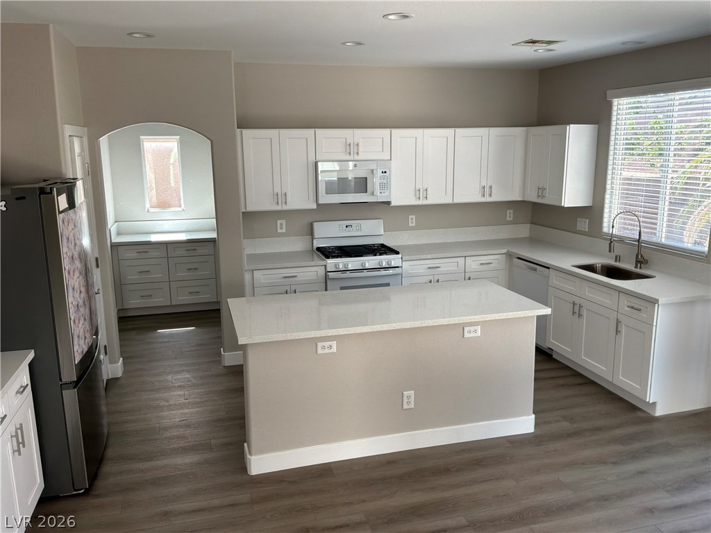 9041 Rendon Street Las Vegas, NV 89143 - Photo 10 of 34 Gleaming stone countertops and matching cabinetry surround a central prep island.
