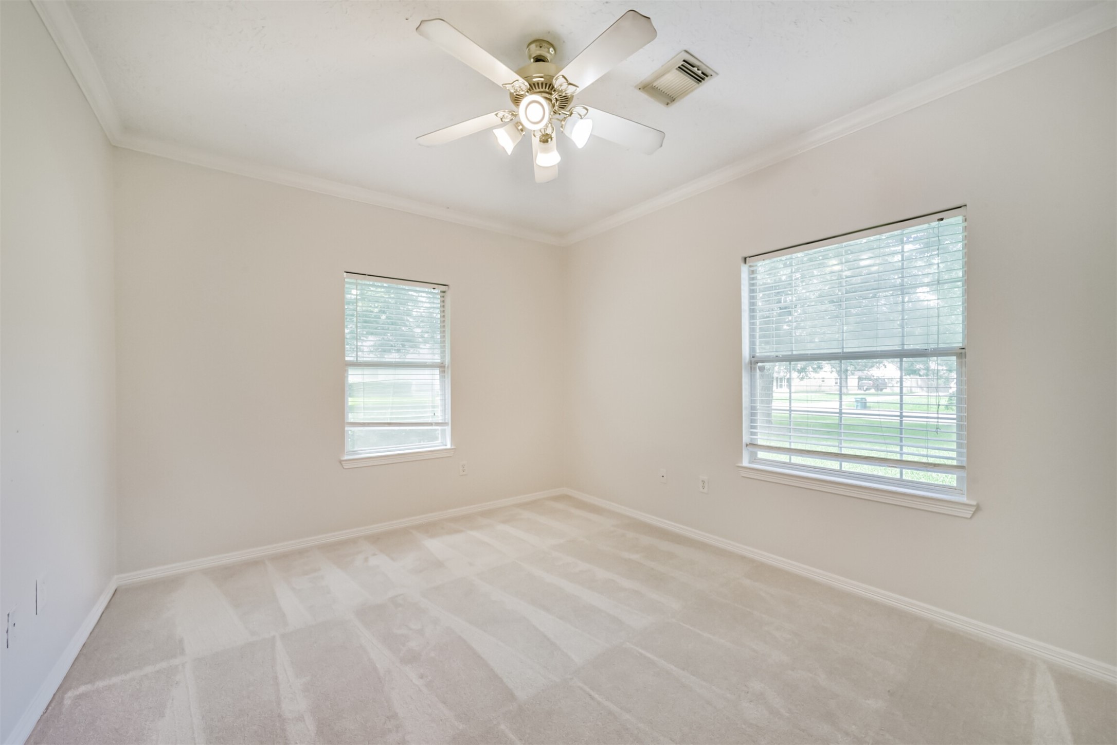 27322 Afton Way Huffman, TX 77336 - Photo 39 of 50 Spacious guest bedroom includes soft neutral tones, crown molding, and easy access to nearby bath areas.