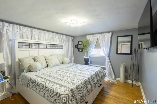 a bedroom with a large bed and a chandelier