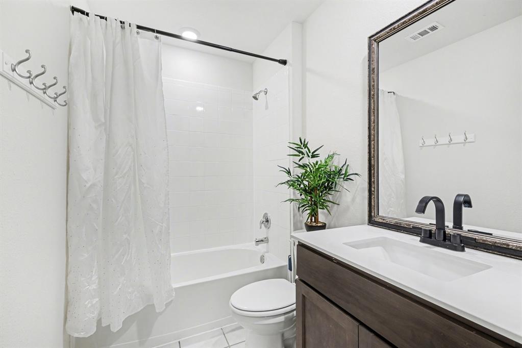 706 Spur Ridge Princeton, TX 75407 - Photo 28 of 36 Bathroom with vanity, light tile patterned flooring, and shower / bath combo