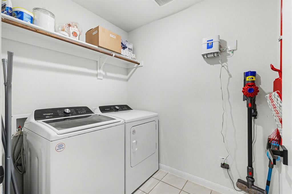 706 Spur Ridge Princeton, TX 75407 - Photo 29 of 36 Laundry area with light tile patterned floors and washer and dryer