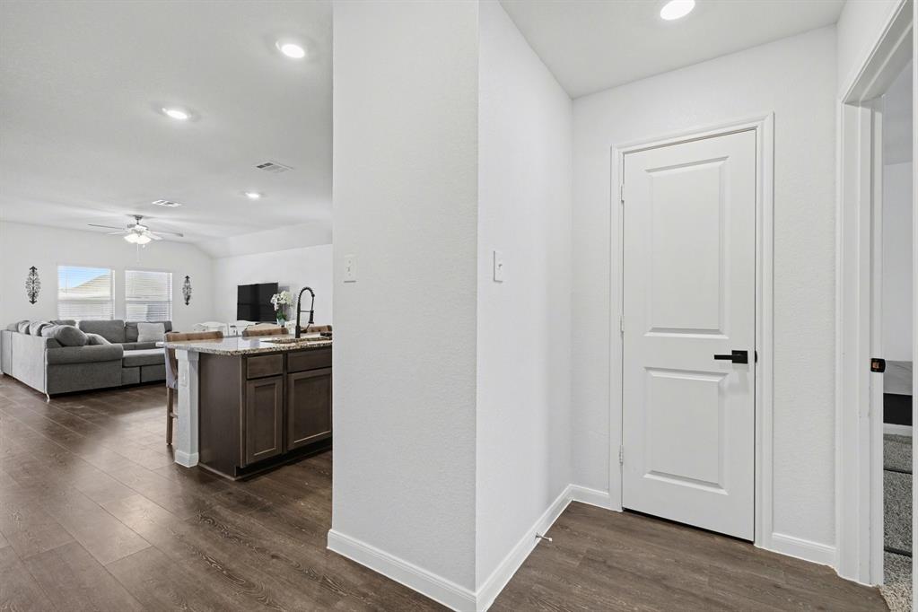 706 Spur Ridge Princeton, TX 75407 - Photo 6 of 36 Corridor with dark wood-style flooring and recessed lighting