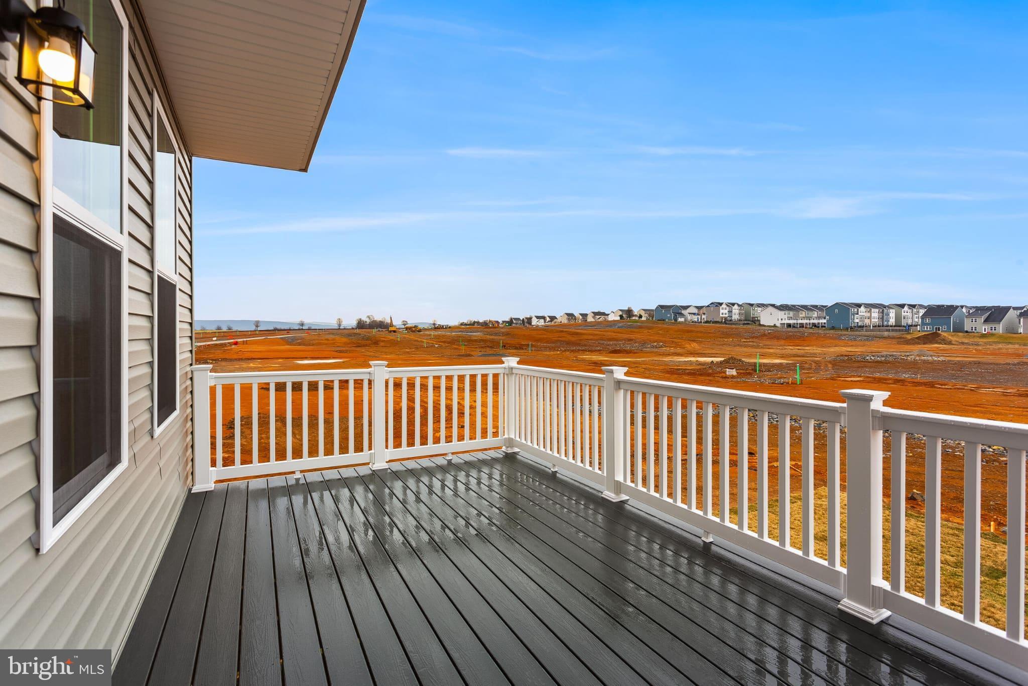 65 Destrier Street Ranson, WV 25438 - Photo 17 of 18 a balcony with wooden floor and city view