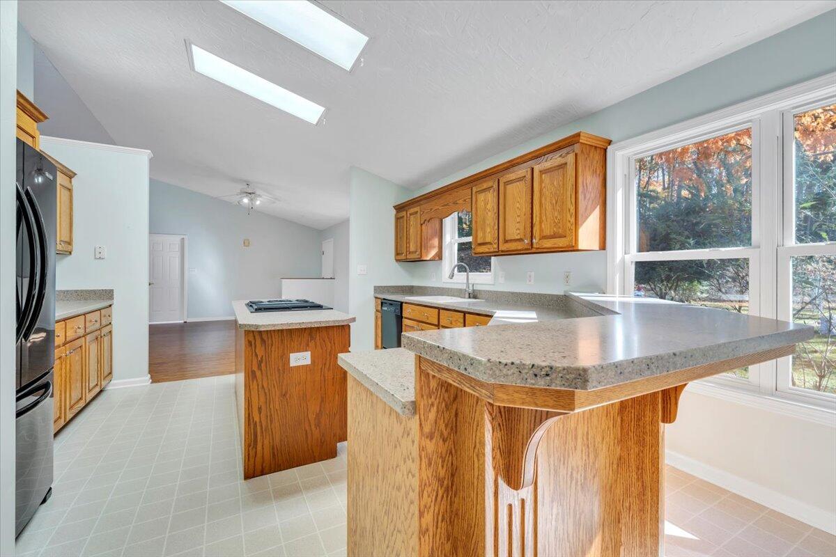 6548 Goodview Road Goodview, VA 24095 - Photo 12 of 113 a kitchen with stainless steel appliances granite countertop a sink a stove and a refrigerator