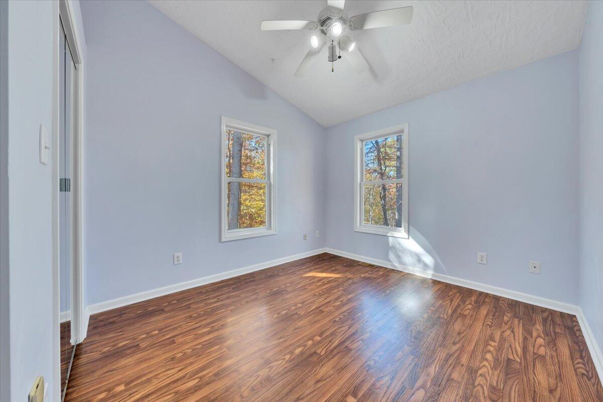 6548 Goodview Road Goodview, VA 24095 - Photo 23 of 113 a view of an empty room with wooden floor and a window