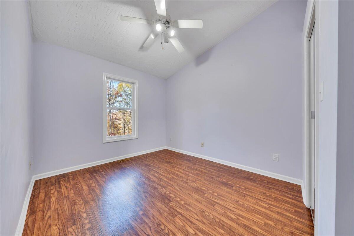 6548 Goodview Road Goodview, VA 24095 - Photo 24 of 113 wooden floor in an empty room with a window