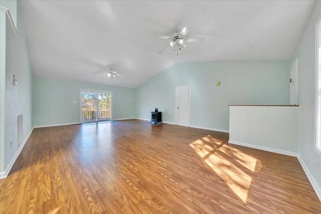 a view of empty room with wooden floor
